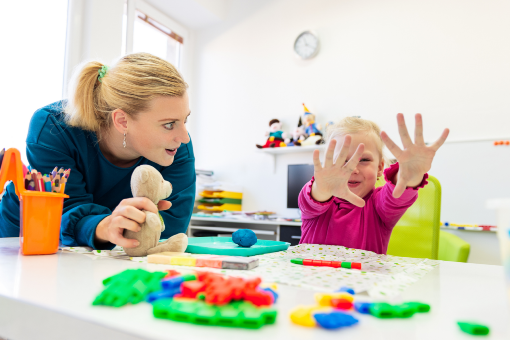 A therapist and child taking part in a playful activity